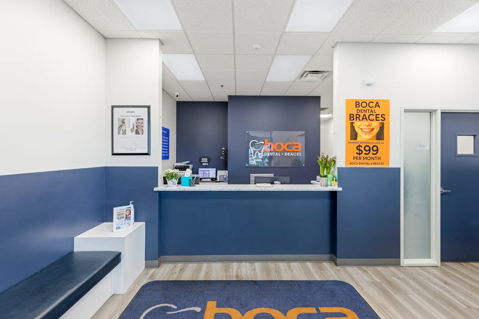 The bright, modern reception and front desk at Boca Specialty Dental and Braces in Reno, with the Boca logo on a navy accent wall